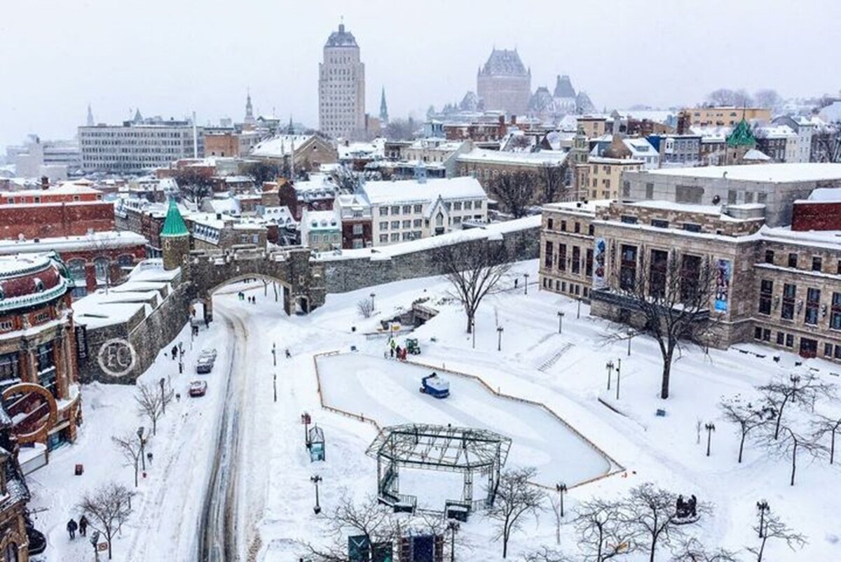 A magical winter view of Old Quebec under the snow, with an outdoor skating rink and the iconic fortifications. A perfect destination for a romantic Valentine's Day getaway