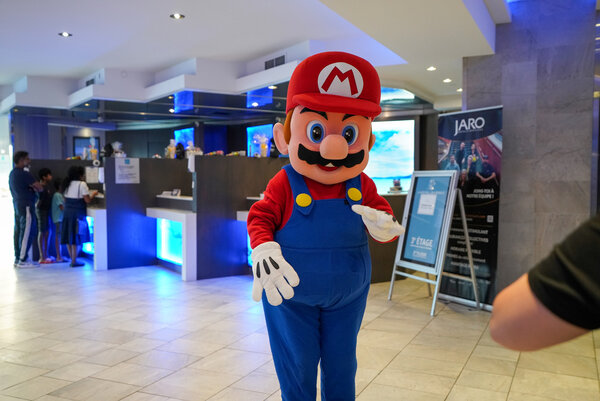 A mascot welcomes visitors to the lively lobby of L'Hôtel Québec